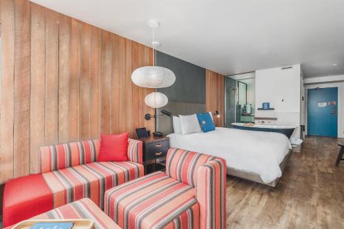 a hotel room with a bed and a couch at Headlands Coastal Lodge & Spa in Pacific City