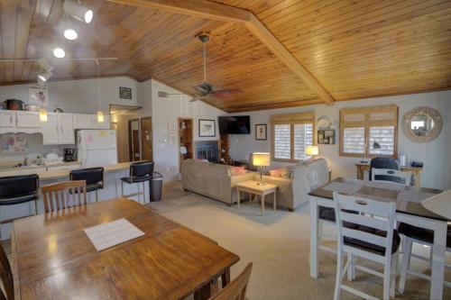 a kitchen and living room with wooden ceilings and a table at 117 Fourth St, Bethany Beach in Bethany Beach