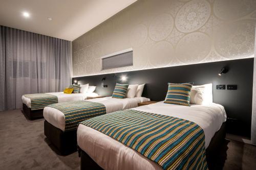 Postel nebo postele na pokoji v ubytování Elite Gold Coast