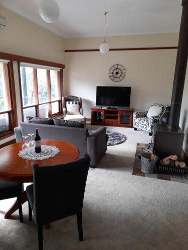 a living room with a couch and a table at Archery Road Estate in Rowland Flat
