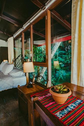 a bedroom with a bed and a table with a bowl on it at Rupa Rupa High Jungle Eco B&B in Machu Picchu