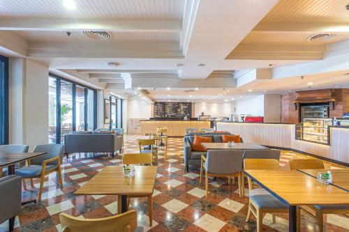 a restaurant with tables and chairs and a bar at JW Marriott Phuket Resort and Spa in Mai Khao Beach
