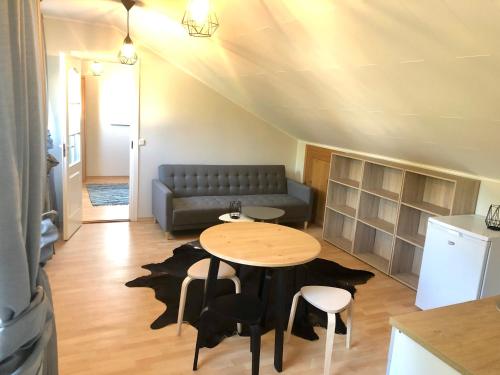 a living room with a table and a couch at Apartment Viiger in Kärdla