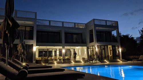 a house with a swimming pool in front of it at Villa Bluu Zanzibar in Jambiani