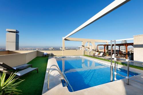 a swimming pool on the roof of a building at Eurostars Gran Valencia in Valencia