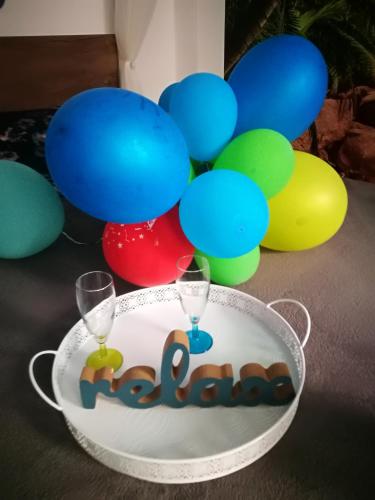 a bowl with two glasses and a sign that says welcome at Iași Jacuzzi Apartment F in Iaşi