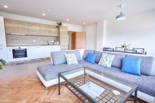 a living room with a couch and a table at Penzion Kozí Horka u Brněnské přehrady in Brno