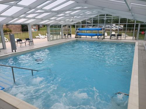 a large swimming pool with chairs and a pool at VVF Normandie Veules-les-Roses in Veules-les-Roses