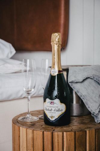 a bottle of champagne and two glasses on a table at Björholmen Hotell & Restaurang in Björholmen