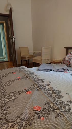 a bed room with a bed with a flower arrangement on it at Words & Swords in Krakow