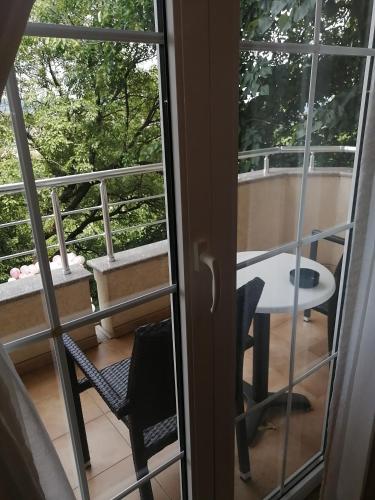 a view of a balcony with a table and a window at B&B Vila Vidikovac in Arandjelovac