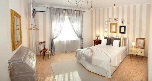 a bedroom with a white bed and a window at LìRìcordi in Isola del Liri