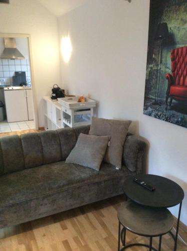 a living room with a couch and a table at Kleines Appartement in Sankt Augustin