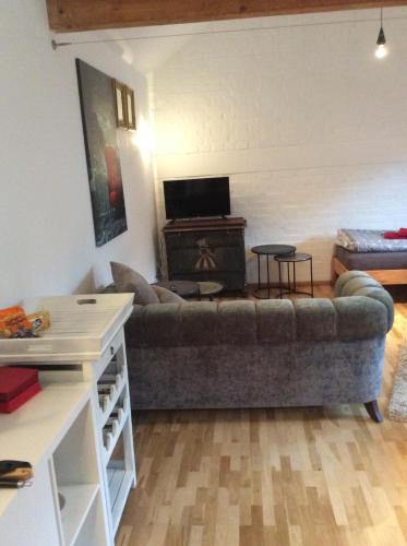 a living room with a couch and a table at Kleines Appartement in Sankt Augustin