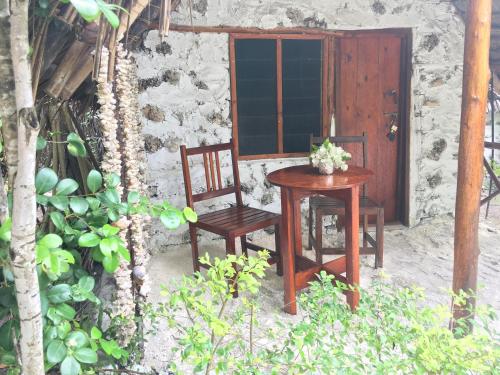 a table and two chairs next to a building at Mount Zion Lodge in Michamvi
