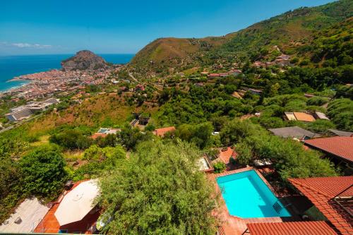 an aerial view of a house with a swimming pool on a hill at Arca Superior in Cefalù