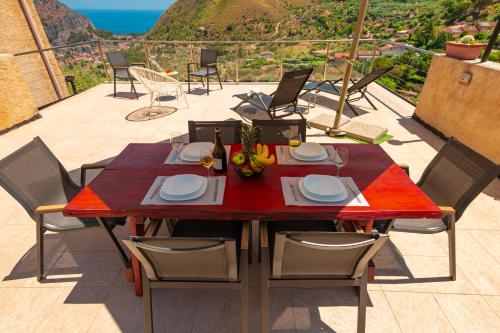 a table and chairs on a patio with a view at Arca Superior in Cefalù