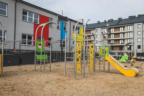 a playground with a slide in the sand at Hullo in Lubawa