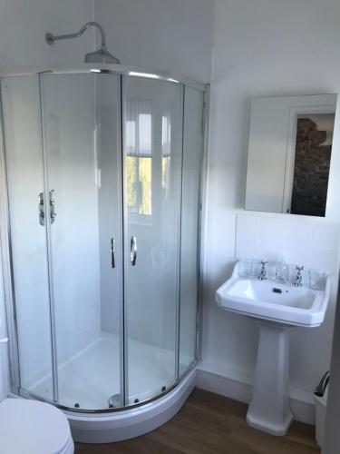 a bathroom with a shower and a sink at Raymond House B&B Penally, Tenby in Penally