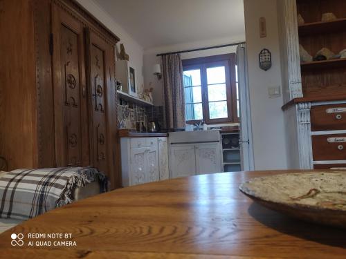 a kitchen with a wooden table and a dining room at Kamiennikove in Kamiennik