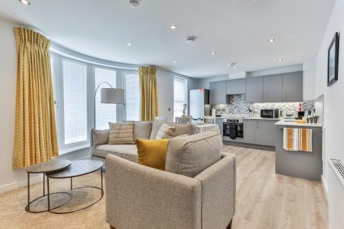 a living room with a couch and a table and a kitchen at Finest Retreats - 13 Belle House - Apartment 3 in Filey