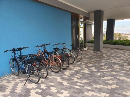 a row of bikes parked next to a wall at Sunset Waves Benidorm by KalmaRent in Benidorm