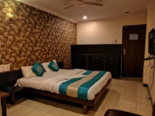 a bedroom with a bed with a wooden wall at Sai Sharan Stay Inn- Near MIDC Turbhe Navi Mumbai in Navi Mumbai