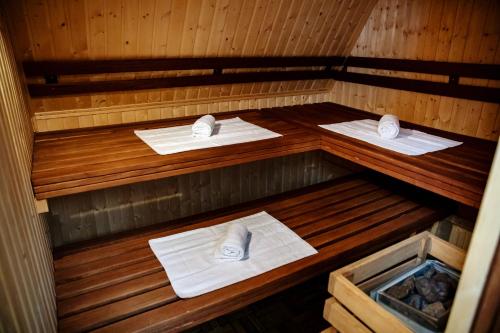 a sauna with three towels and towels in it at Parkhotel Papenburg by Hackmann in Papenburg