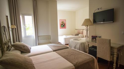 Ένα ή περισσότερα κρεβάτια σε δωμάτιο στο Alborán Chiclana