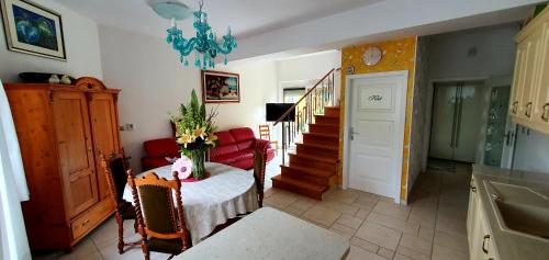 a living room with a table and a chandelier at Apartment Luna in Ptuj