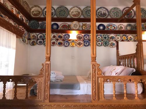 a bedroom with a bed with plates on the wall at Traditional House of Diafani in Karpathos Town