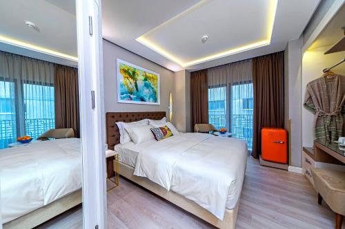 a hotel room with two beds and windows at Barbera Hotel in Istanbul