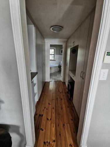 a hallway with a wooden floor in a house at Happy Homes - Imhoffs Gift in Imhoffʼs Gift