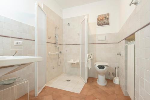 a bathroom with a shower and a toilet and a sink at Fattoria Pian Di Rocca in Castiglione della Pescaia