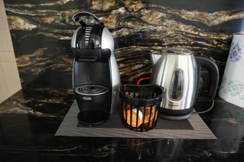 a coffeemaker and a coffee maker on a counter at Heart of Vilnius Apartment in Vilnius