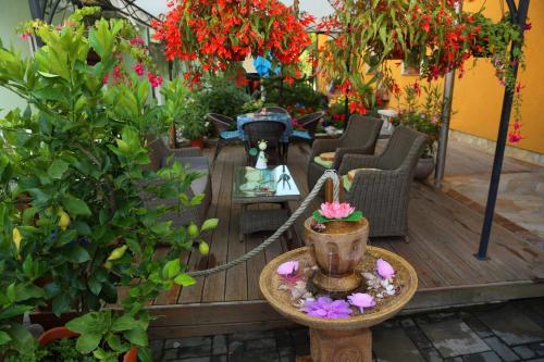 a patio with flowers and a table and chairs at Apartment Luna in Ptuj