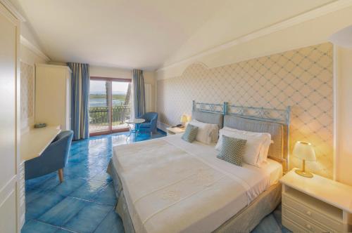 a hotel room with a bed and a balcony at Hotel Santa Gilla in Capoterra