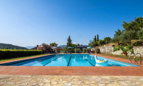 a swimming pool with a person in a float in the middle at Residence al Foionco in Lucca