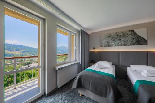 Posteľ alebo postele v izbe v ubytovaní Hotel Pod Jedlami