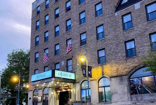 a large brick building with a store in front of it at The Hotel Ojibway, Trademark Collection by Wyndham in Sault Ste. Marie