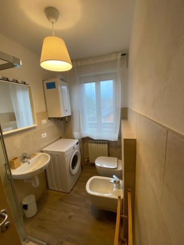 a bathroom with a sink and a toilet and a mirror at Chez Tina in Asiago