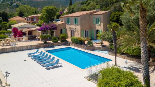 a villa with a swimming pool and a house at Villa La Cigale Gaia's Villas in Théoule-sur-Mer