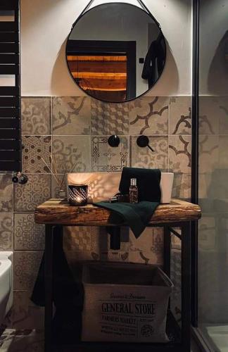 a counter in a bathroom with a mirror at B&B Il Fabbro Chambre in Castelmauro