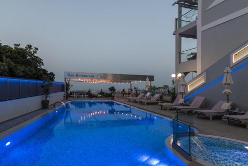 a large swimming pool on the side of a building at Denise Beach Hotel in Laganas
