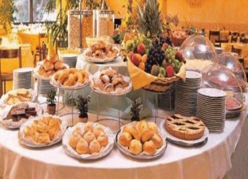 a table with many plates of food on it at Park Hotel Ristorante Ca' Bianca in Istrana