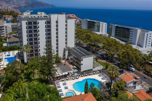 an aerial view of a city with a pool and buildings at Hotel Girassol - Suite Hotel in Funchal