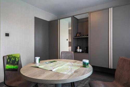 a room with a table and chairs with a map on it at Hotel Pod Jedlami in Wisła
