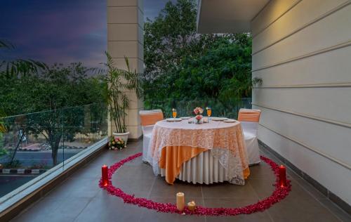 a table on the balcony of a building at Hotel Saket 27 in New Delhi