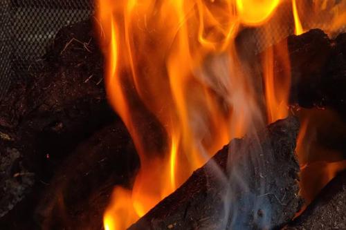a fire is burning in a grill with flames at Luxury 'Cois Abhainn' Self Catering Apartment in Foxford
