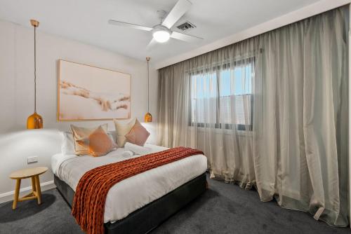 a bedroom with a bed and a large window at StayCentral - Moonee Ponds Penthouse in Melbourne